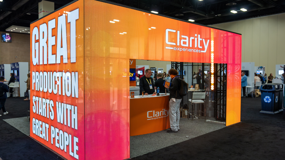Image of a orange and pink custom trade show booth at Cvent Connect 2025