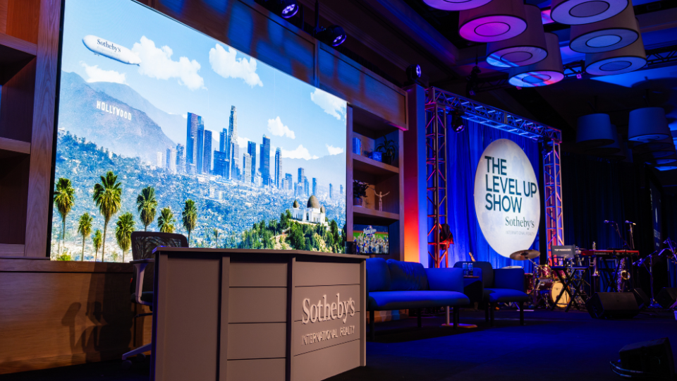 image of a main stage at an event that looks designed to be a daily show